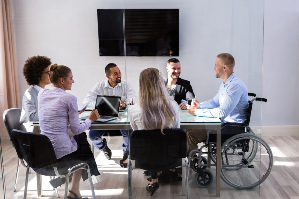 Man in wheelchair at team meeting with colleagues