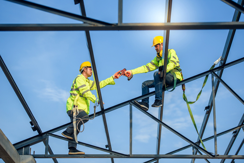 two construction workers working at height